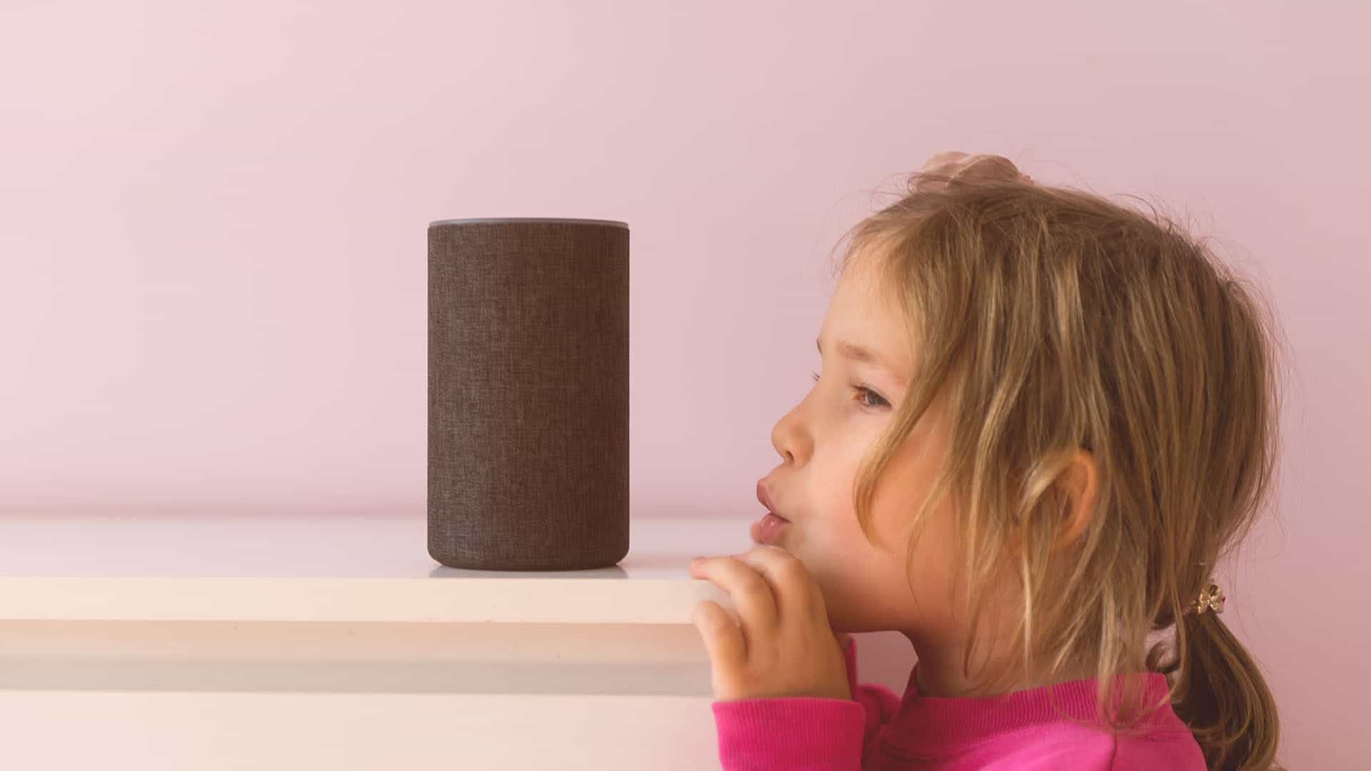 A small girl speaking to an Amazon Echo